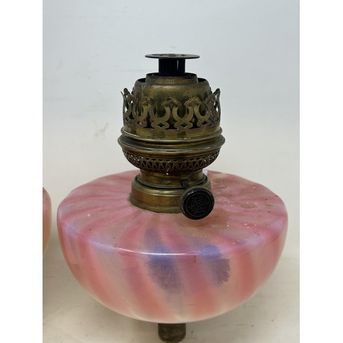 1099 - A pair of Vaseline glass oil lamp reservoirs, 17 cm diameter (2)