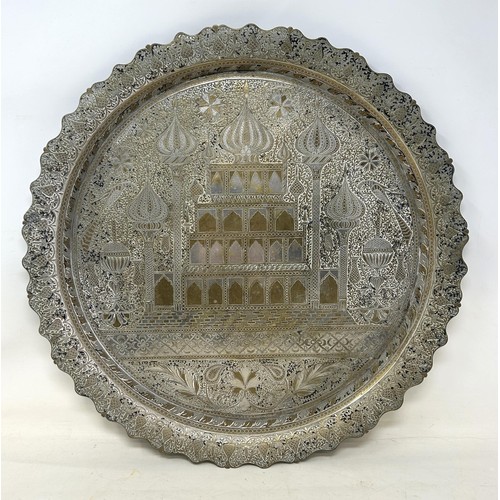 1101 - An Islamic brass tray, with silver coloured metal inlay, decorated building, 39 cm diameter