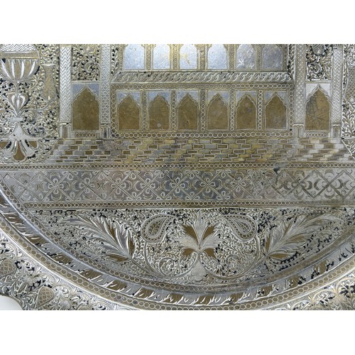 1101 - An Islamic brass tray, with silver coloured metal inlay, decorated building, 39 cm diameter