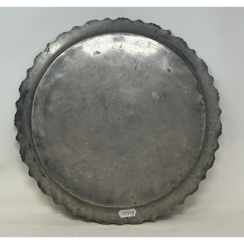 1101 - An Islamic brass tray, with silver coloured metal inlay, decorated building, 39 cm diameter