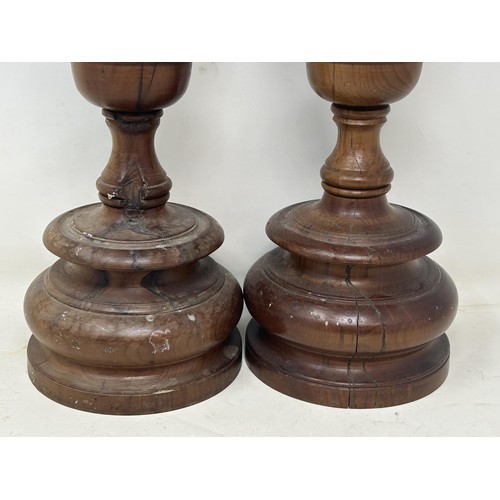 1102 - A pair of turned wooden candlesticks, 48 cm high (2)