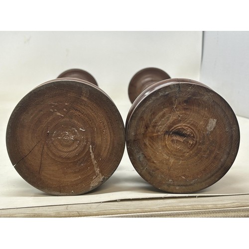 1102 - A pair of turned wooden candlesticks, 48 cm high (2)