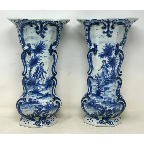 1103 - A pair of Delft vases, 33 cm high, and a Delft plate, 37 cm high (3)