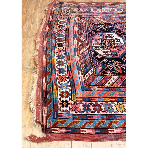 1272 - A Persian blue ground rug, centre with repeating geometric forms and multiple borders, 260 x 118 cm