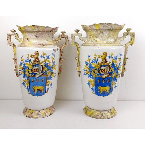 1104 - A pair of late 19th/early 20th century French vases, decorated armorials, 44 cm high (2)