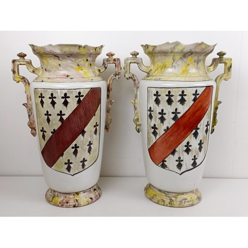 1104 - A pair of late 19th/early 20th century French vases, decorated armorials, 44 cm high (2)