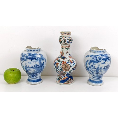 1085 - A pair of blue and white Delft vases, 16 cm high, and another, 23 cm high (3)