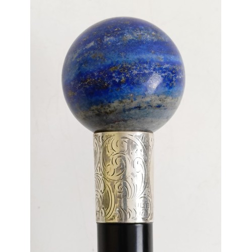 1125 - A walking stick, with lapis lazuli handle and silver collar, marks rubbed