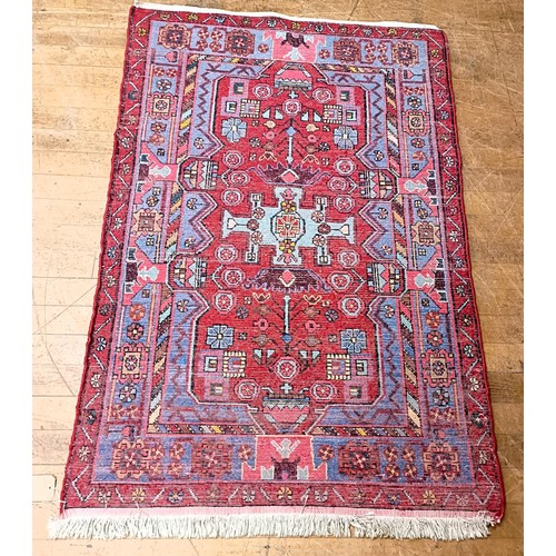 1268 - A Persian red ground rug, centre with stylised foliate forms, with main red border, 165 x 119 cm