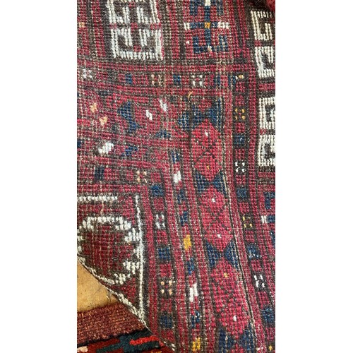 1205 - An Afghan red ground rug, 222 x 129 cm, and a red ground rug, 150 x 90 cm (2)