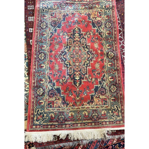 1205 - An Afghan red ground rug, 222 x 129 cm, and a red ground rug, 150 x 90 cm (2)