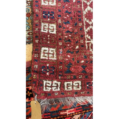 1205 - An Afghan red ground rug, 222 x 129 cm, and a red ground rug, 150 x 90 cm (2)