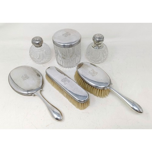 419 - A Danish silver coloured metal part dressing table set, comprising a hand mirror, two brushes, a sil... 