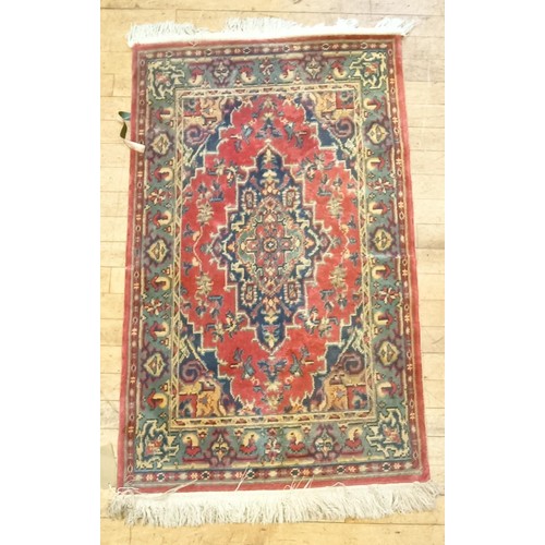 1205 - An Afghan red ground rug, 222 x 129 cm, and a red ground rug, 150 x 90 cm (2)