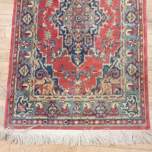 1205 - An Afghan red ground rug, 222 x 129 cm, and a red ground rug, 150 x 90 cm (2)