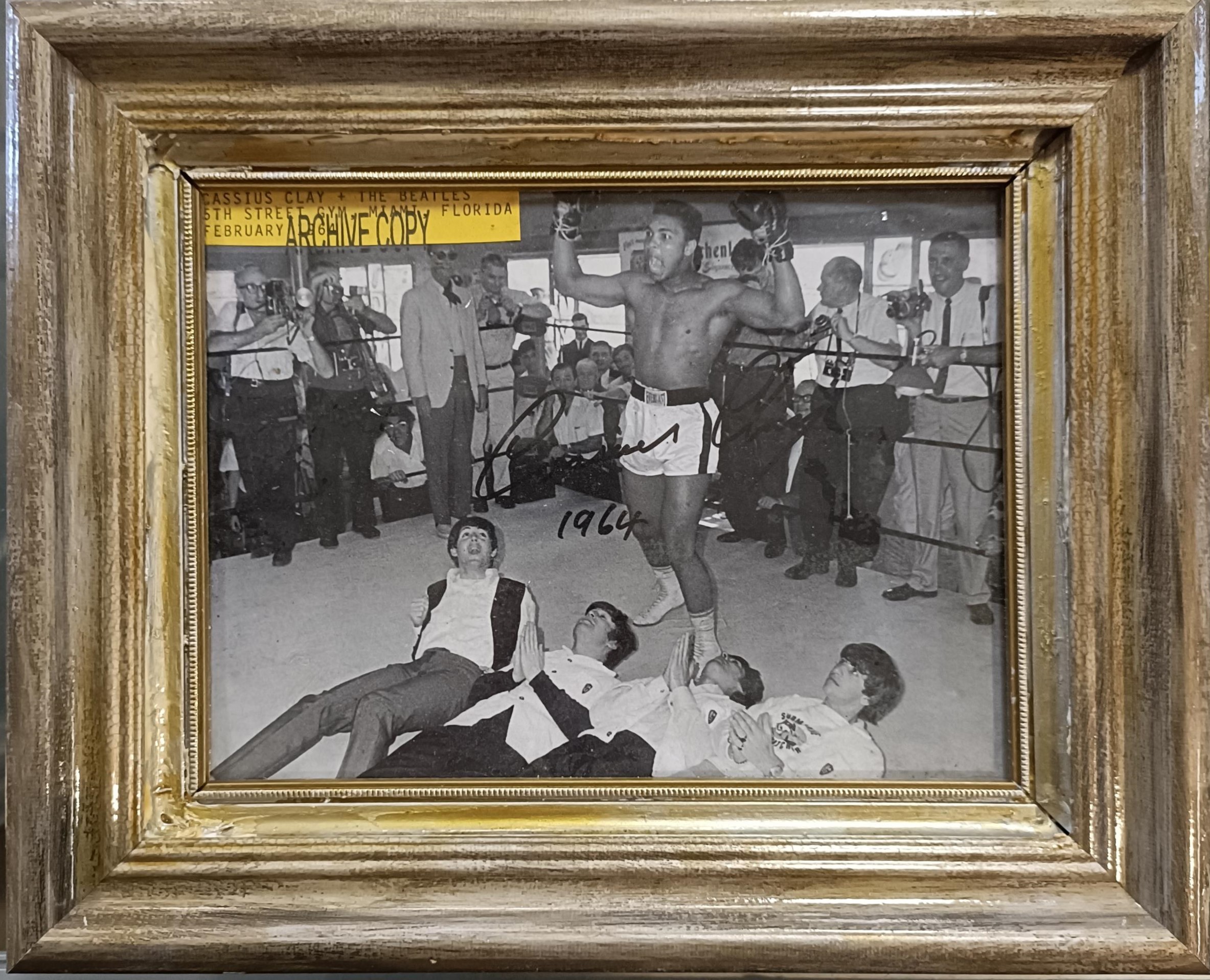 The Beatles and Cassius Clay monochrome photograph at auction