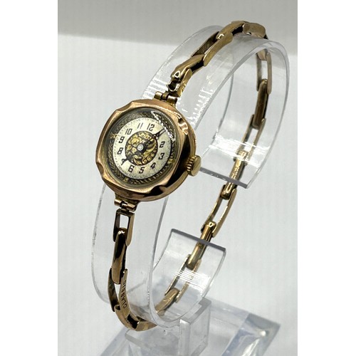 831 - A ladies yellow metal wristwatch, on an expandable strap