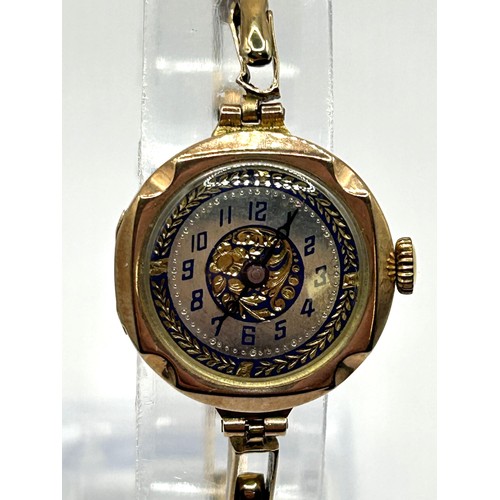 831 - A ladies yellow metal wristwatch, on an expandable strap