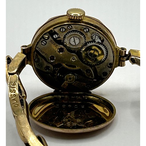 831 - A ladies yellow metal wristwatch, on an expandable strap