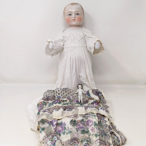 223 - A German Frozen Charlotte ceramic doll, 37 cm, and another smaller, 8 cm (2)