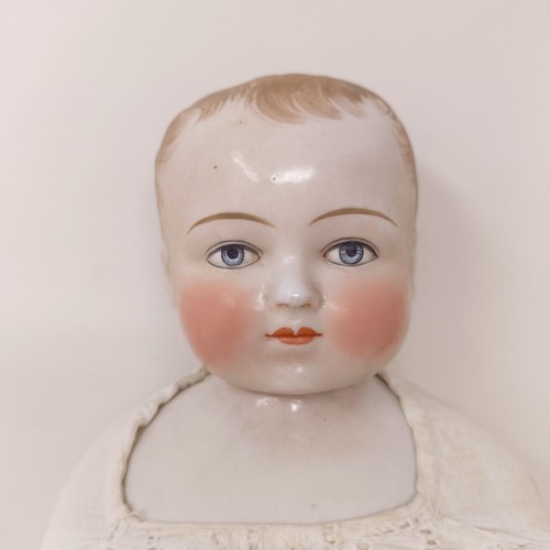 223 - A German Frozen Charlotte ceramic doll, 37 cm, and another smaller, 8 cm (2)