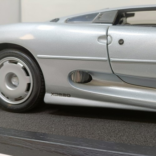 230 - A Maisto 1:12 model of a Jaguar XJ220, in a display case