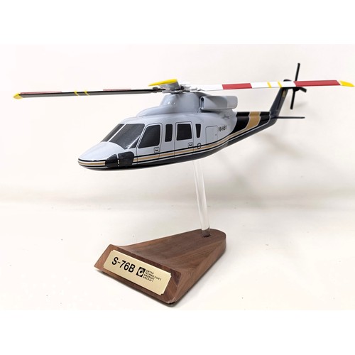 237 - A model of a Sikorsky S-76B helicopter on a stand, 33 cm wide