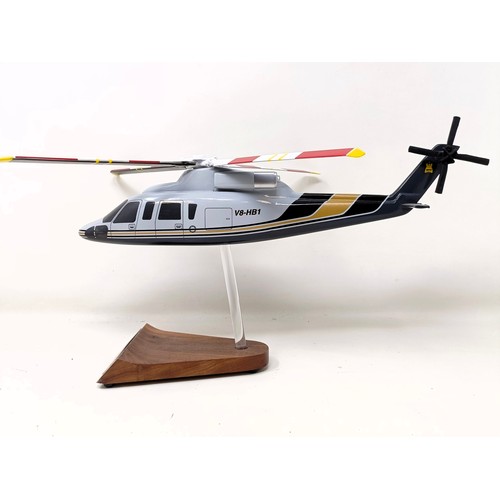 237 - A model of a Sikorsky S-76B helicopter on a stand, 33 cm wide