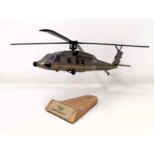 241 - A model of a Sikorsky S-70A helicopter, on a stand, 31 cm