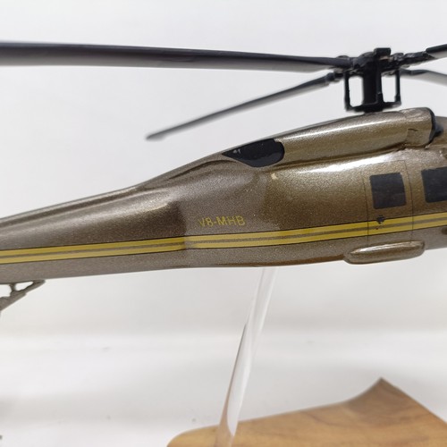 241 - A model of a Sikorsky S-70A helicopter, on a stand, 31 cm