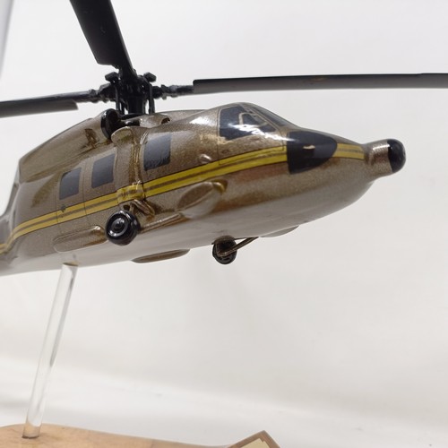 241 - A model of a Sikorsky S-70A helicopter, on a stand, 31 cm