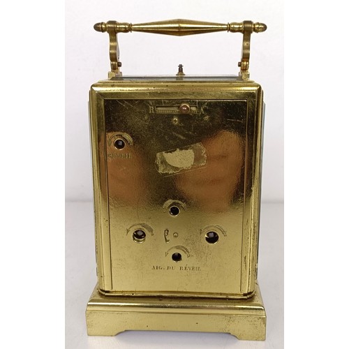 842 - A French carriage clock, with repeast, the silvered dial with alarm dial, in a brass four pillar cas... 