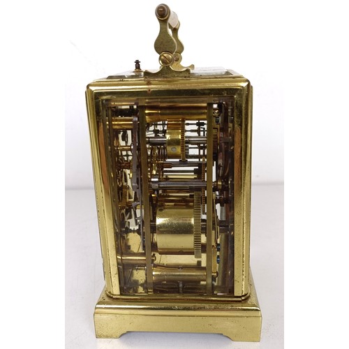 842 - A French carriage clock, with repeast, the silvered dial with alarm dial, in a brass four pillar cas... 