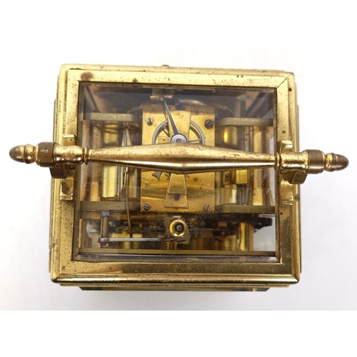 842 - A French carriage clock, with repeast, the silvered dial with alarm dial, in a brass four pillar cas... 