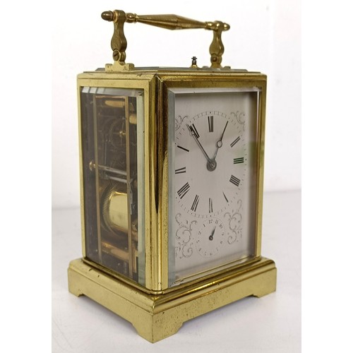 842 - A French carriage clock, with repeast, the silvered dial with alarm dial, in a brass four pillar cas... 