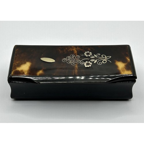 1016 - A Victorian snuff box, the top with silver coloured metal inlaid decoration, 9.5 cm wide