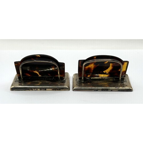1018 - A pair of silver and tortoiseshell menu holders, decorated a running fox and a grouse (2)
