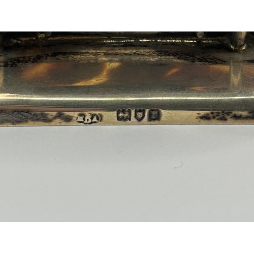 1018 - A pair of silver and tortoiseshell menu holders, decorated a running fox and a grouse (2)