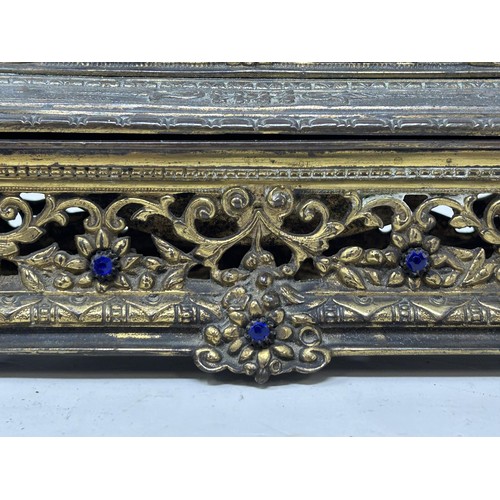 1021 - A gilt brass and bejewelled inkstand, 25 cm wide