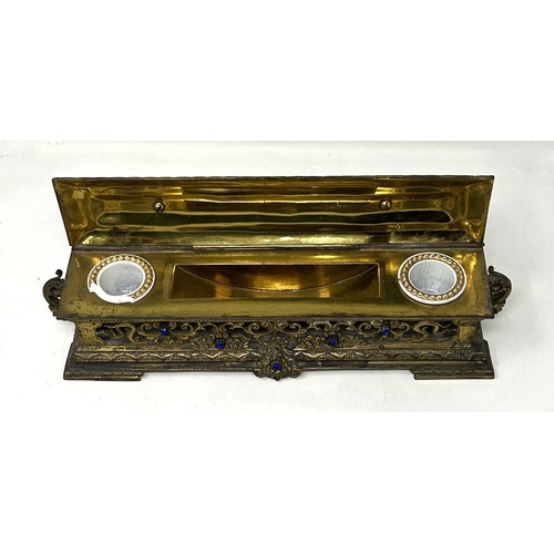 1021 - A gilt brass and bejewelled inkstand, 25 cm wide