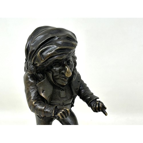 1023 - A bronze caricature figure, on a square base, possibly a hat pin stand, 13 cm high