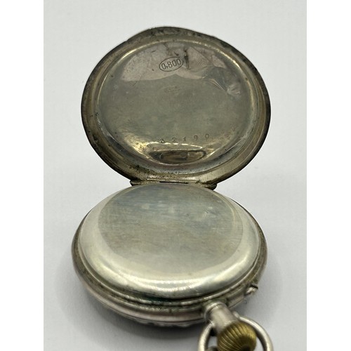 844 - A ladies silver coloured metal fob watch, in an engraved case, stamped .800, in a fitted box, with a... 