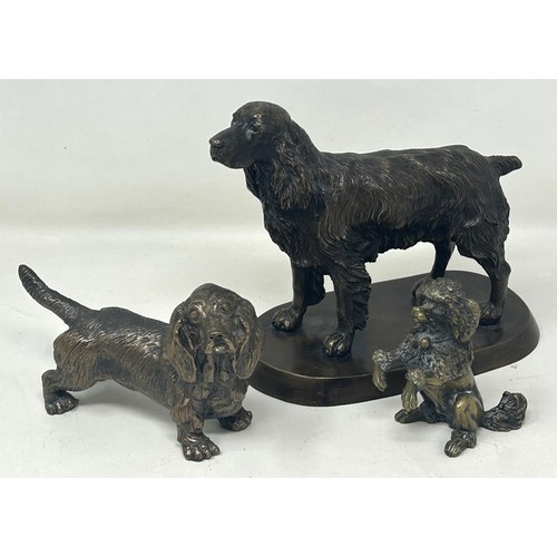 1024 - A bronze figure of a cocker spaniel, on a rounded rectangular base, 14 cm high, a bronze figure of a... 