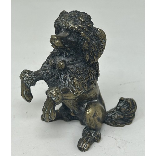 1024 - A bronze figure of a cocker spaniel, on a rounded rectangular base, 14 cm high, a bronze figure of a... 