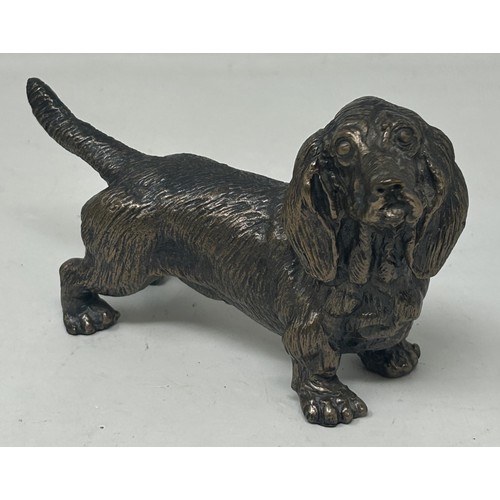 1024 - A bronze figure of a cocker spaniel, on a rounded rectangular base, 14 cm high, a bronze figure of a... 