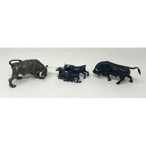 1026 - A bronze figure of a bull, 5.5 cm high, and two other similar bull figures/groups (3)
