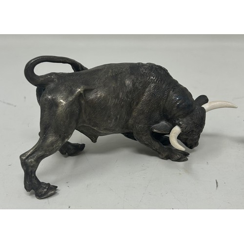 1026 - A bronze figure of a bull, 5.5 cm high, and two other similar bull figures/groups (3)