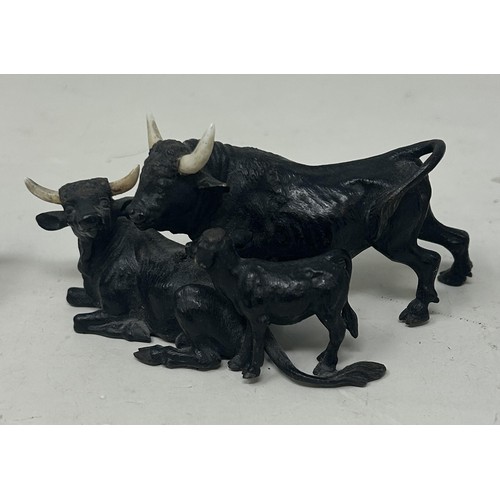1026 - A bronze figure of a bull, 5.5 cm high, and two other similar bull figures/groups (3)