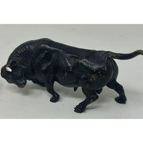 1026 - A bronze figure of a bull, 5.5 cm high, and two other similar bull figures/groups (3)