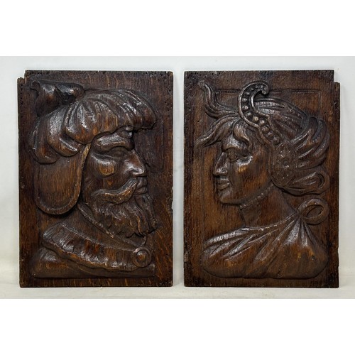983 - A pair of 17th century style oak panels, carved opposing bust portraits, 26.5 x 19 cm (2)
